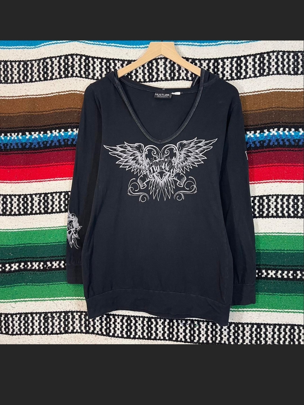 Hustler Hollywood Hooded Black Long Sleeve V-Neck with Winged Graphic Top. L